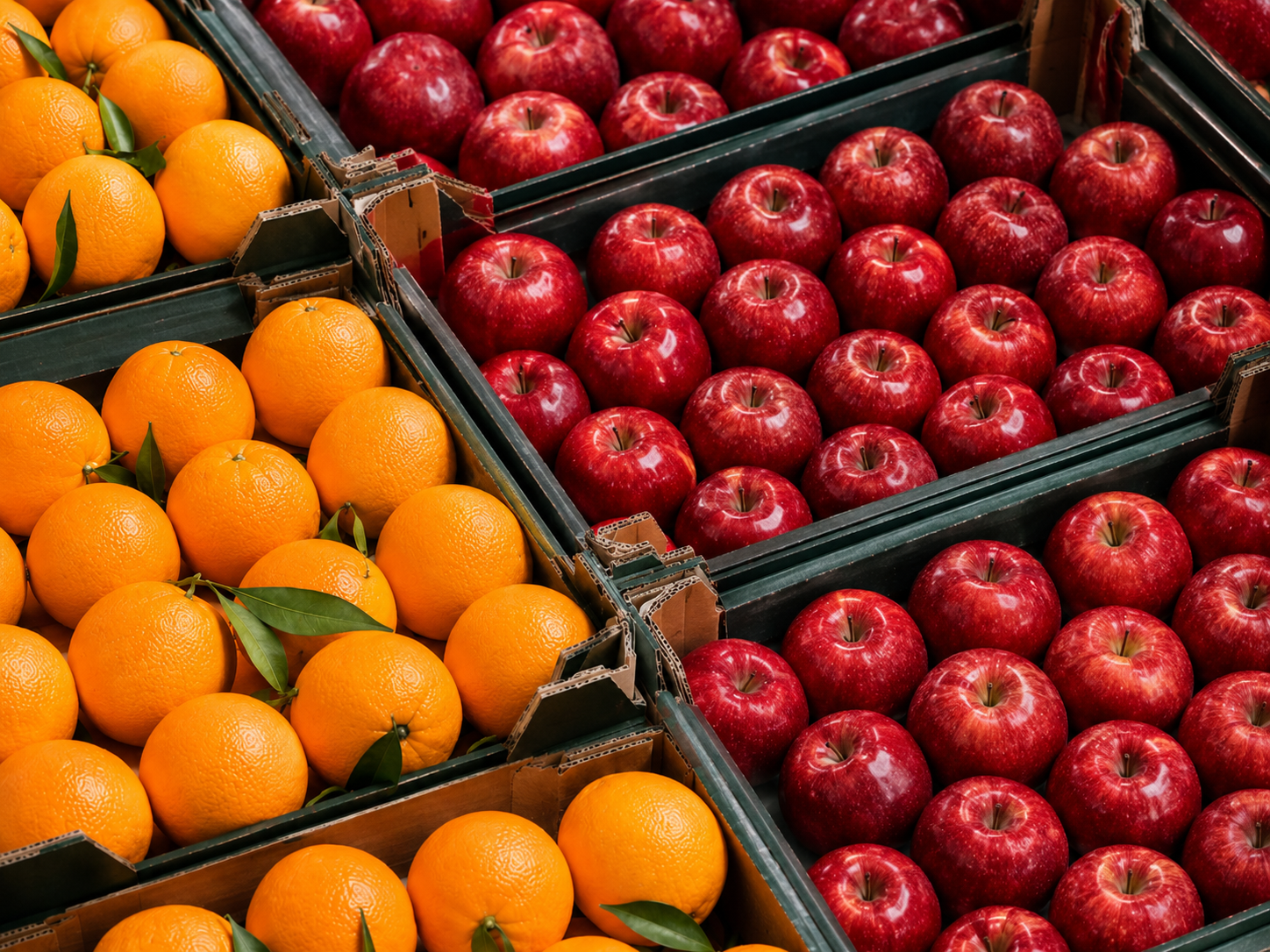Fresh apples and oranges in commercial packaging